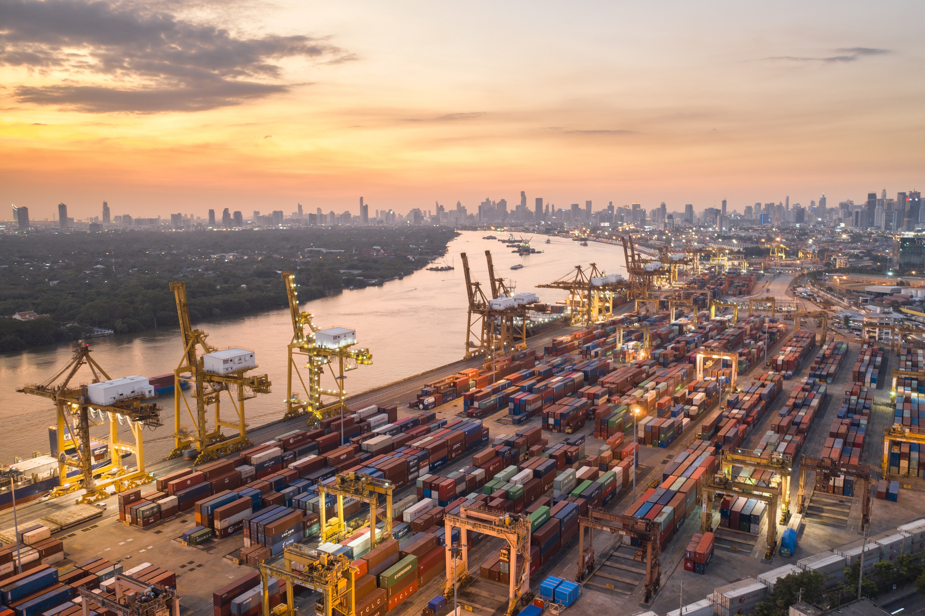 Sunset evening port shipping. Logistics and transportation of Container Cargo ship and Cargo plane with working 